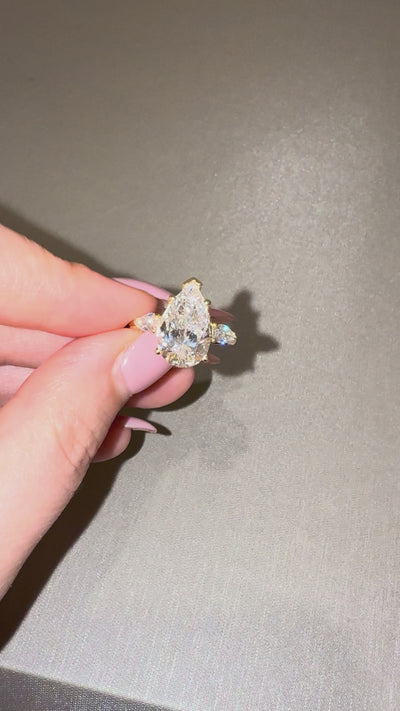Ness Pear Three Stone Engagement Ring close-up — pear lab diamond with side stones, yellow gold — ELUL by Elizabeth