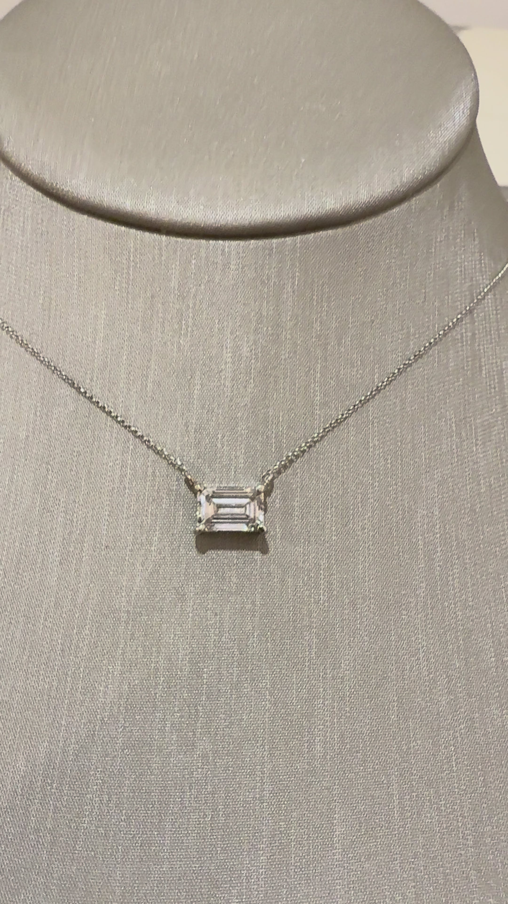 Muse Emerald Bezel Necklace worn on neck — 2 ct emerald-cut lab diamond, yellow gold bezel — ELUL by Elizabeth